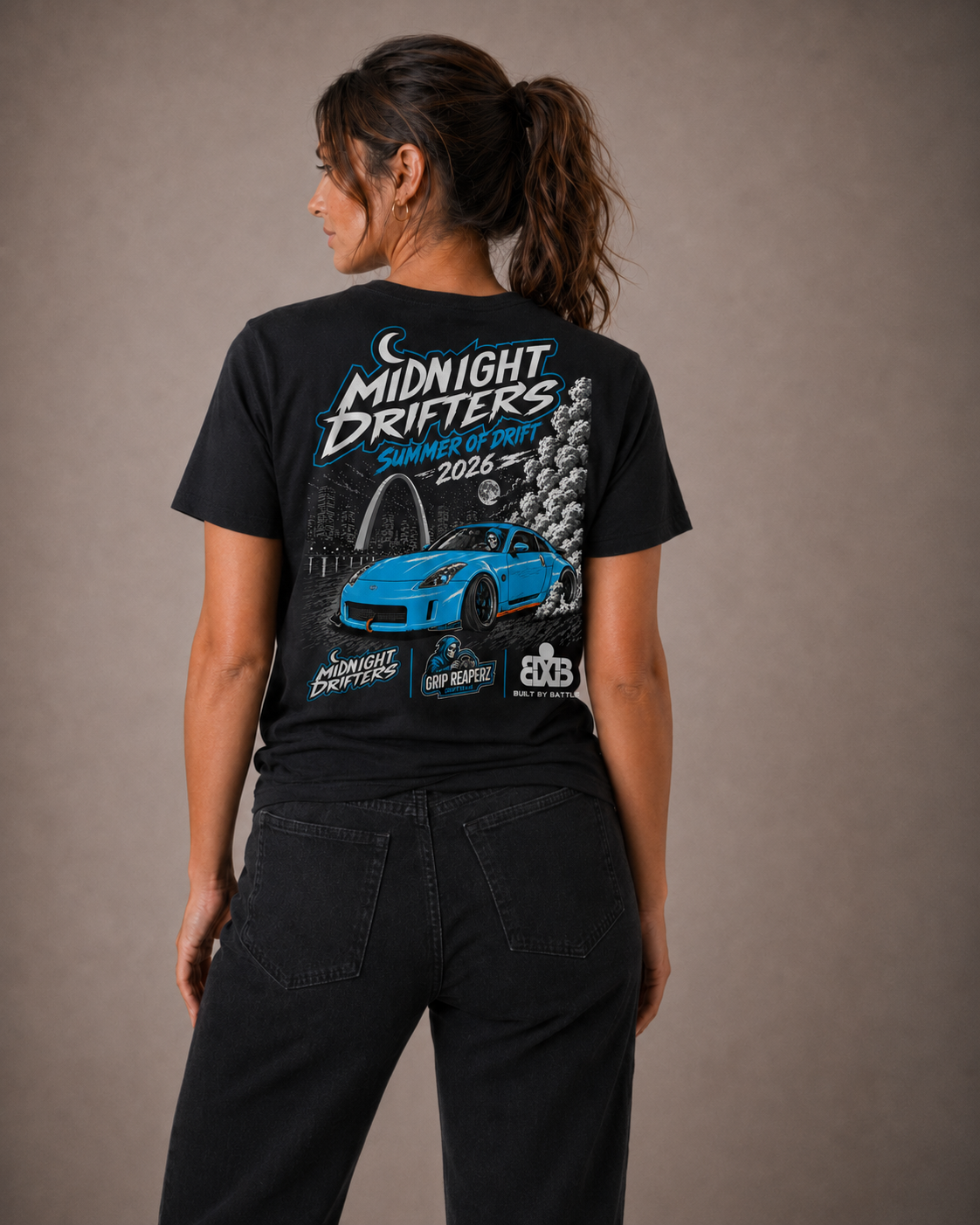 Person wearing a black t-shirt with 'Midnight Drifters' graphic design on the back.